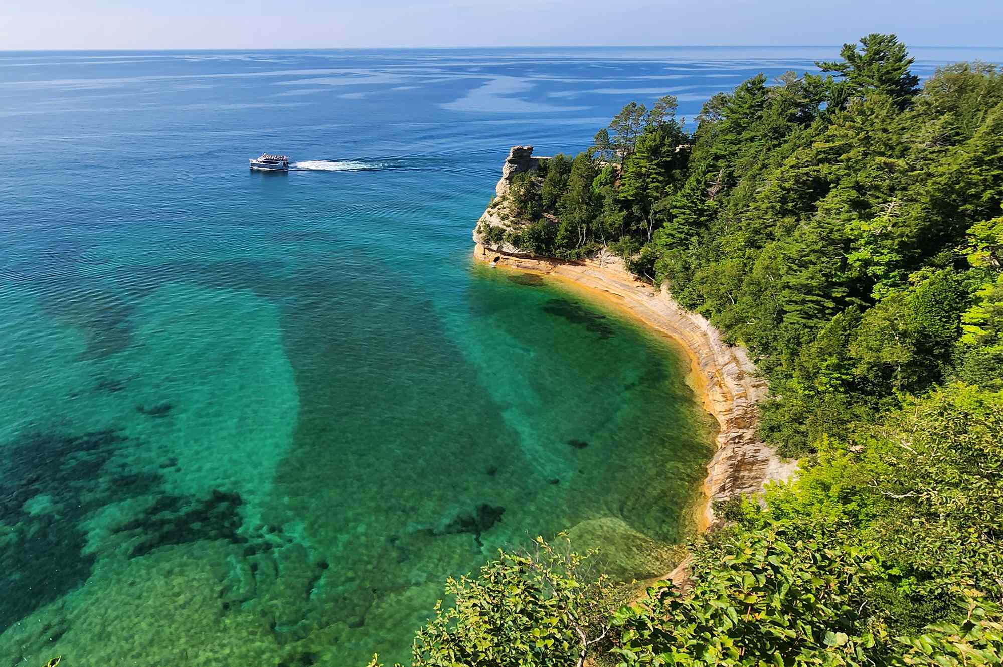 This Midwest Lake Has Rainbow Cliffs and Striking Sea Caves Framing Clear, Caribbean-blue Water